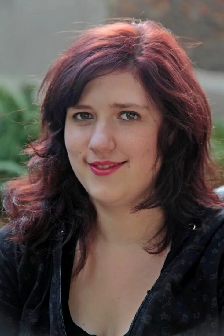 Natural-light headshot of a woman outdoors