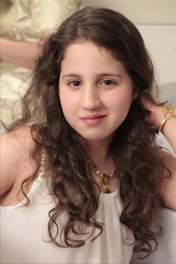 Natural portrait of a young girl with long curls